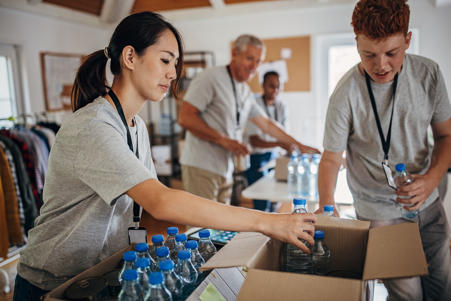 Volunteers sorting donations in boxes