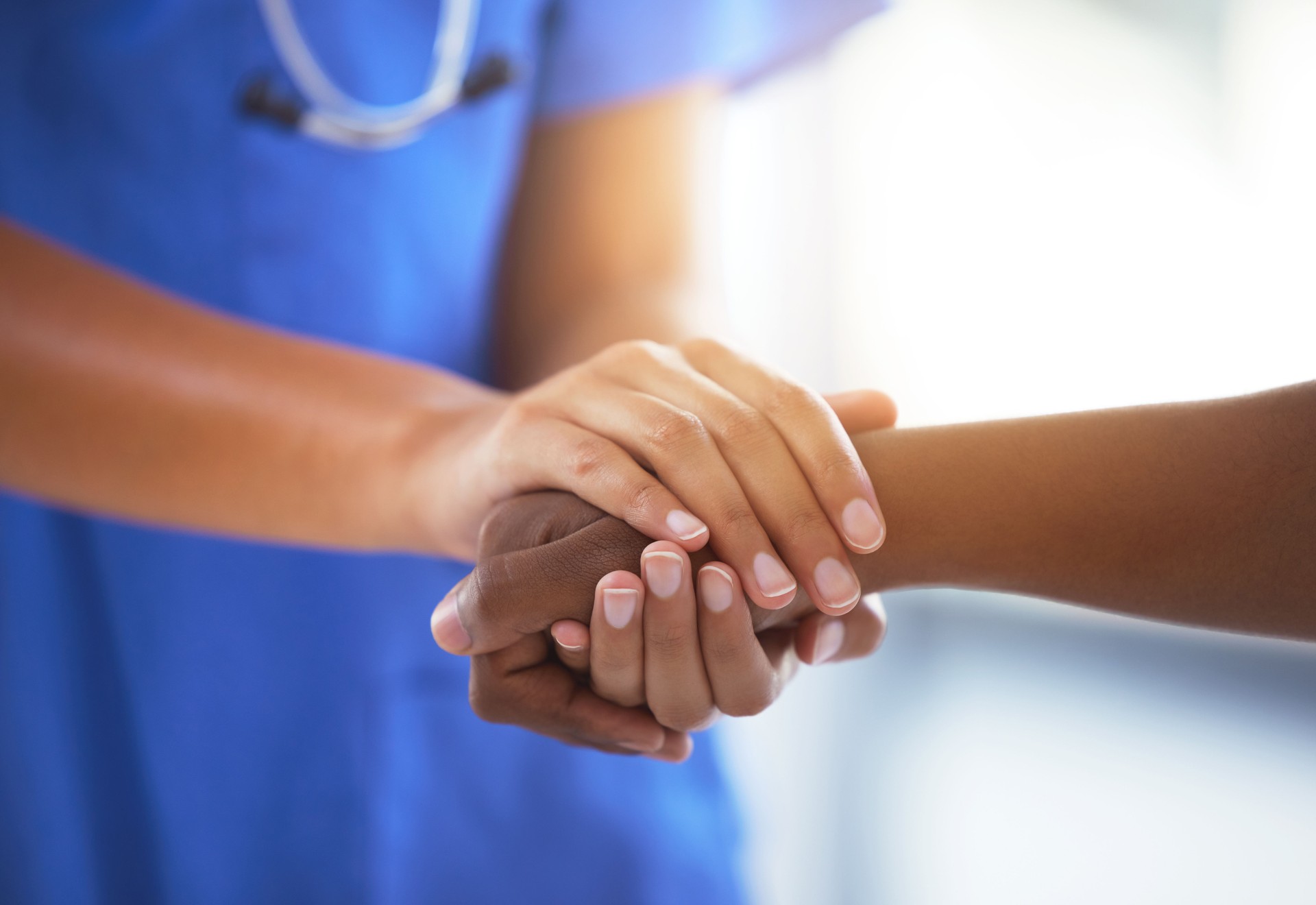 Shot of an unrecognizable doctor holding hands with her patient during a consultation
